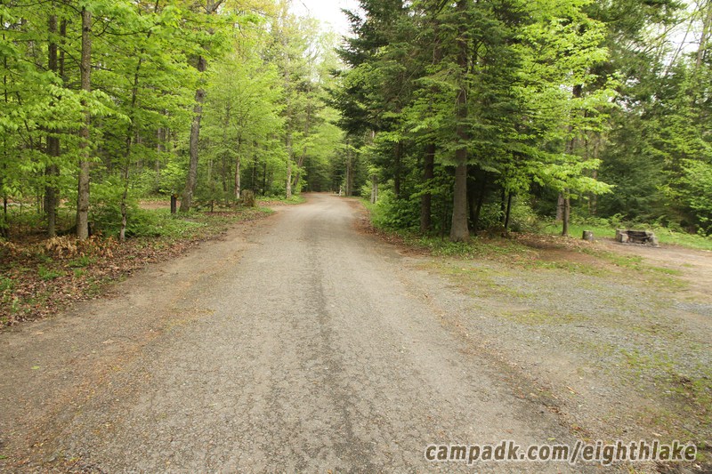 Campsite Photo of Site 25 at Eighth Lake Campground, New York - View Down Road From Campsite