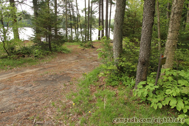 Campsite Photo of Site 112 at Eighth Lake Campground, New York - Looking at Site From Road Sign Visible