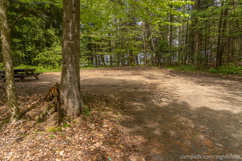 Campsite Photo of Site 25 at Eighth Lake Campground, New York - Looking at Site from Road Sign Visible