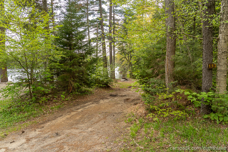 Campsite Photo of Site 112 at Eighth Lake Campground, New York - Looking at Site from Road Sign Visible