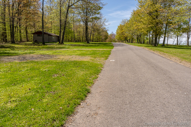Campsite Photo of Site 261 at Fair Haven Beach State Park, New York - View Down Road from Campsite