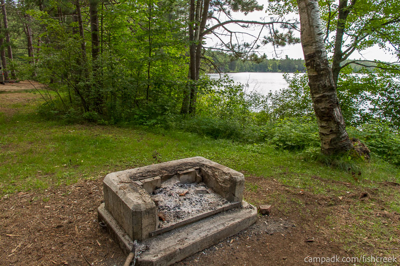Campsite Photo of Site 46 at Fish Creek Pond Campground, New York - Fireplace View