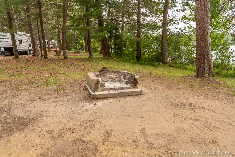 Campsite Photo of Site 106 at Fish Creek Pond Campground, New York - Fireplace View