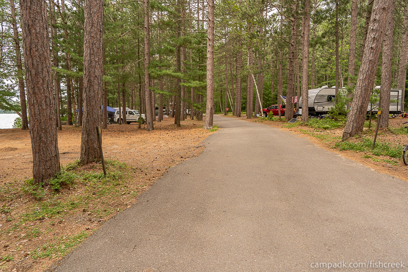Campsite Photo of Site 106 at Fish Creek Pond Campground, New York - View Down Road from Campsite