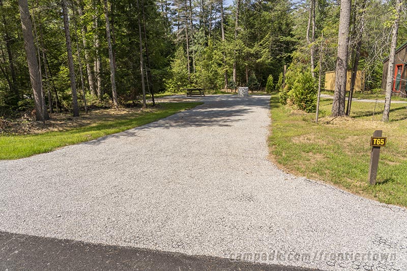 Campsite Photo of Site T65 at Frontier Town Campground, New York - Looking at Site from Road Sign Visible