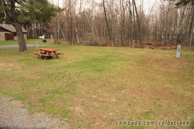 Campsite Photo of Site 67 at Coles Creek State Park, New York - Looking at Site from Road Sign Visible
