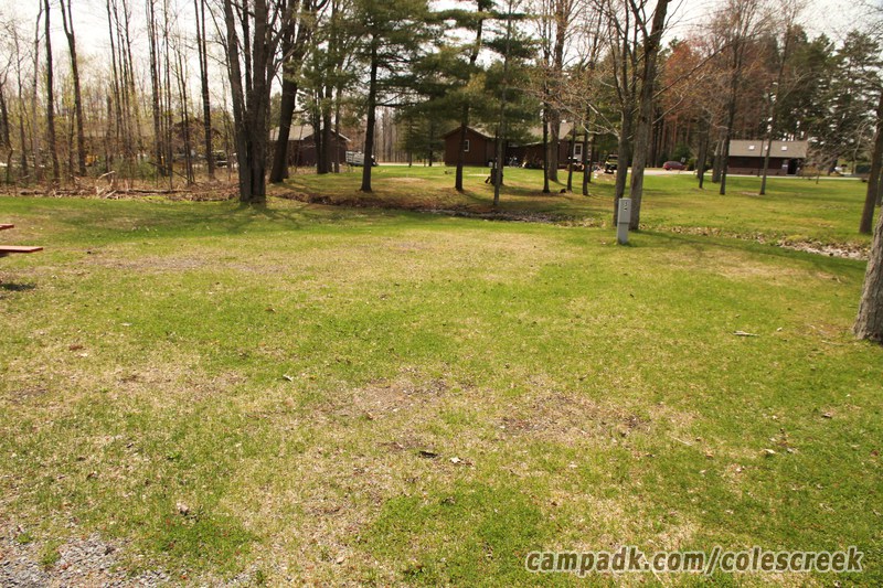 Campsite Photo of Site 5 at Coles Creek State Park, New York - Looking at Site from Road Sign Visible