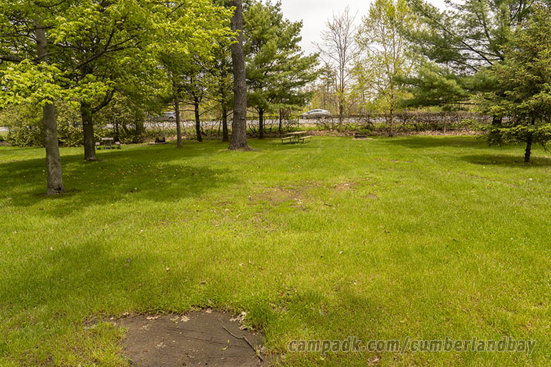 Campsite Photo of Site 21 at Cumberland Bay State Park, New York - Looking at Site from Road Sign Visible