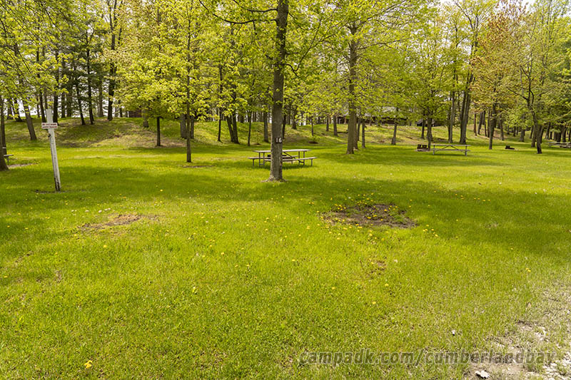Campsite Photo of Site 16 at Cumberland Bay State Park, New York - Looking at Site from Road Sign Visible