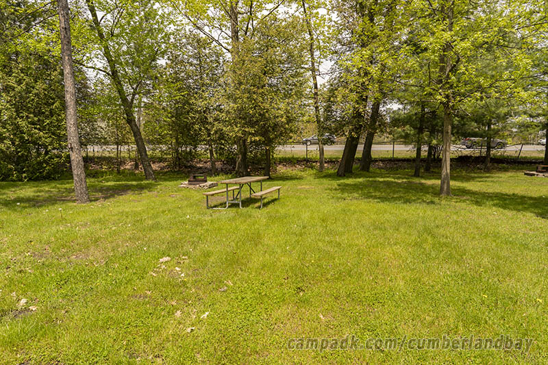Campsite Photo of Site 11 at Cumberland Bay State Park, New York - Looking at Site from Road Sign Visible
