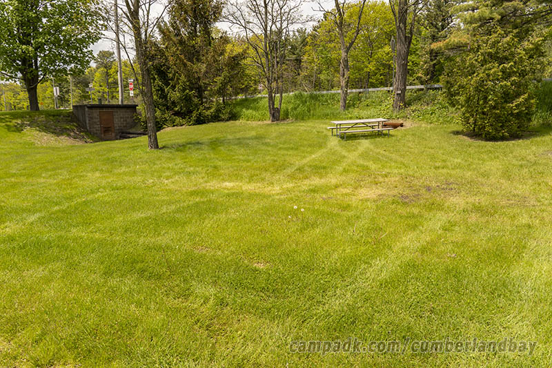 Campsite Photo of Site 148 at Cumberland Bay State Park, New York - Looking at Site from Road Sign Visible