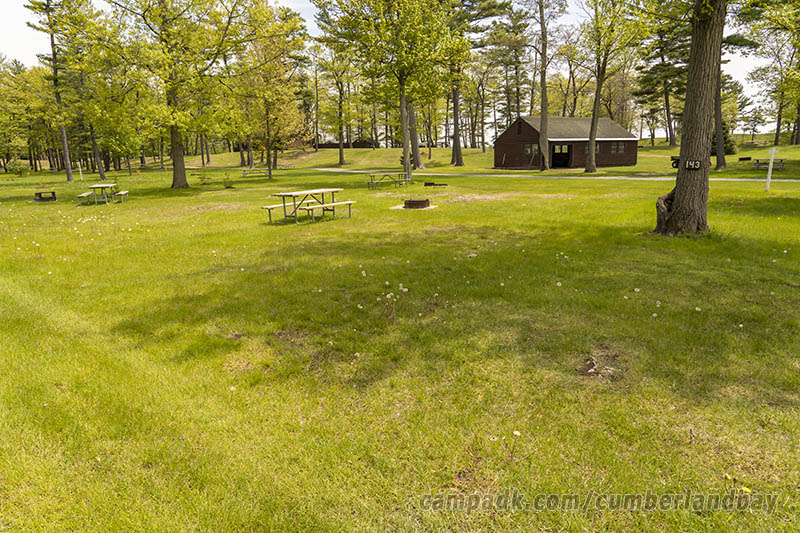Campsite Photo of Site 143 at Cumberland Bay State Park, New York - Looking at Site from Road Sign Visible