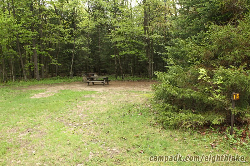 Campsite Photo of Site 15 at Eighth Lake Campground, New York - Looking at Site from Road Sign Visible