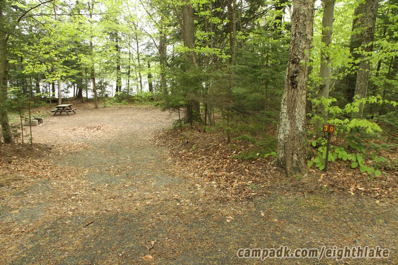 Campsite Photo of Site 39 at Eighth Lake Campground, New York - Looking at Site from Road Sign Visible