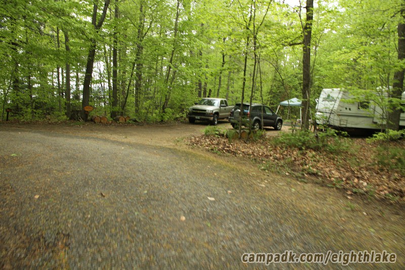 Campsite Photo of Site 44 at Eighth Lake Campground, New York - Looking at Site from Road Sign Visible