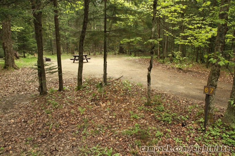 Campsite Photo of Site 67 at Eighth Lake Campground, New York - Looking at Site from Road Sign Visible