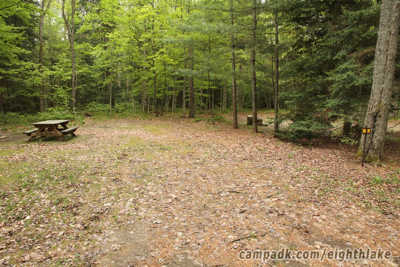 Campsite Photo of Site 82 at Eighth Lake Campground, New York - Looking at Site from Road Sign Visible