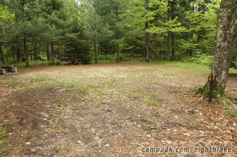 Campsite Photo of Site 87 at Eighth Lake Campground, New York - Looking at Site From Road Sign Visible
