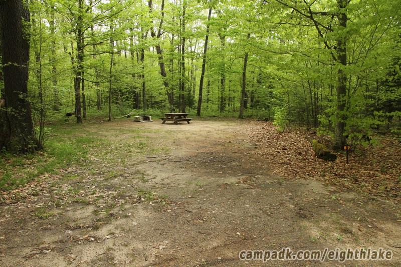 Campsite Photo of Site 97 at Eighth Lake Campground, New York - Looking at Site from Road Sign Visible