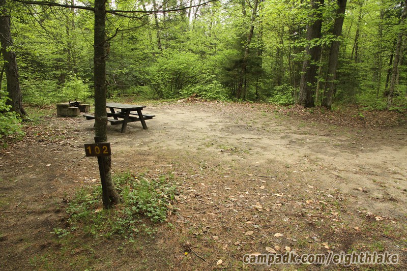 Campsite Photo of Site 102 at Eighth Lake Campground, New York - Looking at Site from Road Sign Visible