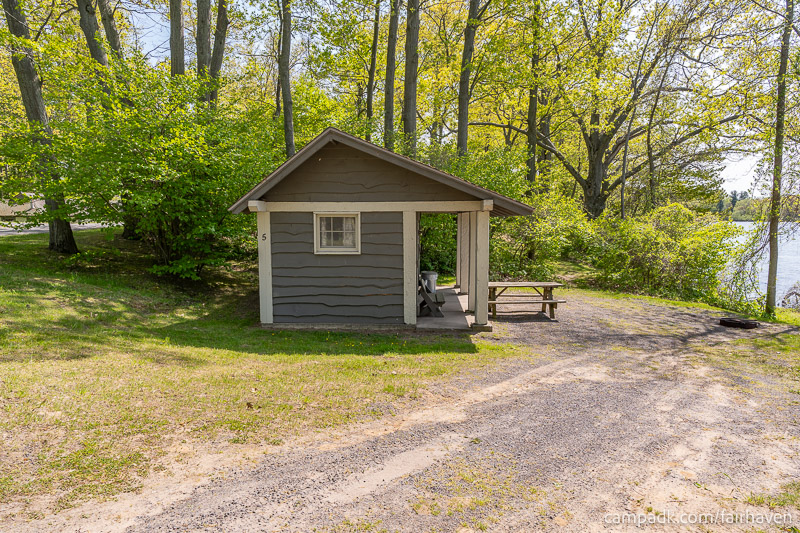 Campsite Photo of Site 5 at Fair Haven Beach State Park, New York - Looking at Site from Road Sign Visible