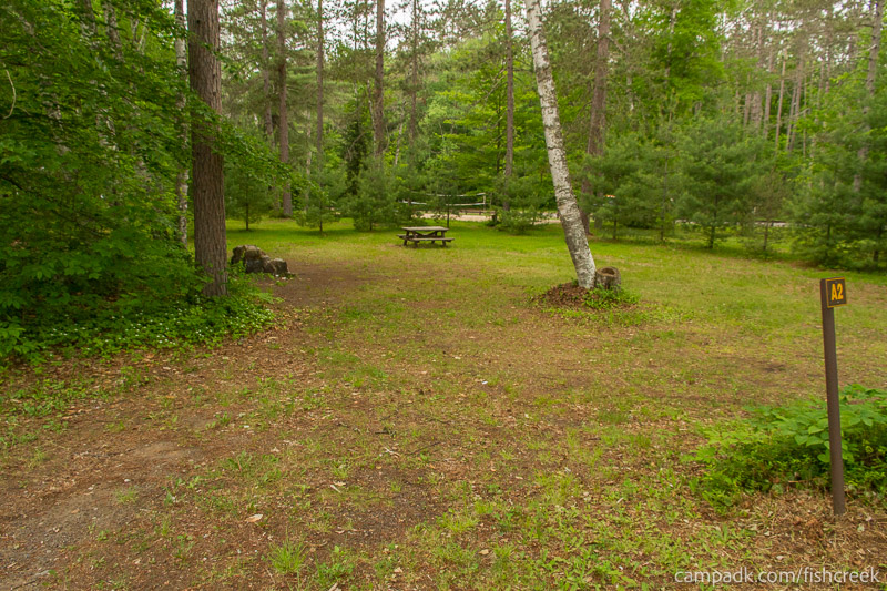 Campsite Photo of Site 66 at Fish Creek Pond Campground, New York - Looking at Site from Road Sign Visible