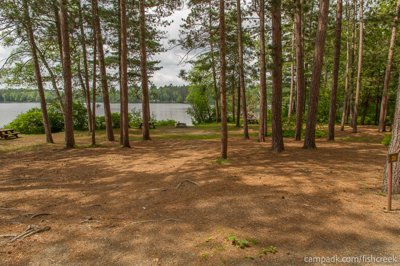 Campsite Photo of Site 28 at Fish Creek Pond Campground, New York - Looking at Site from Road Sign Visible