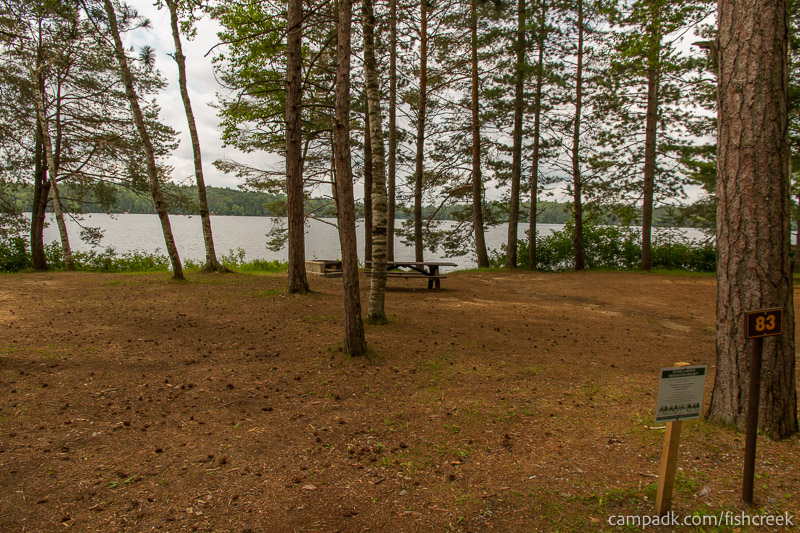 Campsite Photo of Site 115 at Fish Creek Pond Campground, New York - Looking at Site from Road Sign Visible