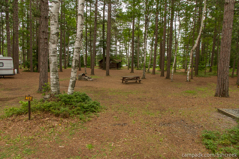 Campsite Photo of Site 100 at Fish Creek Pond Campground, New York - Looking at Site from Road Sign Visible