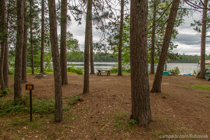 Campsite Photo of Site 75 at Fish Creek Pond Campground, New York - Looking at Site from Road Sign Visible