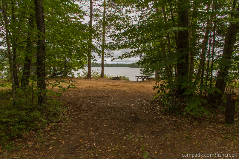 Campsite Photo of Site 176 at Fish Creek Pond Campground, New York - Looking at Site from Road Sign Visible