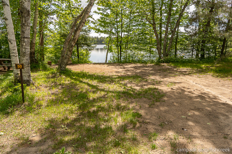 Campsite Photo of Site 60 at Fish Creek Pond Campground, New York - Looking at Site from Road Sign Visible