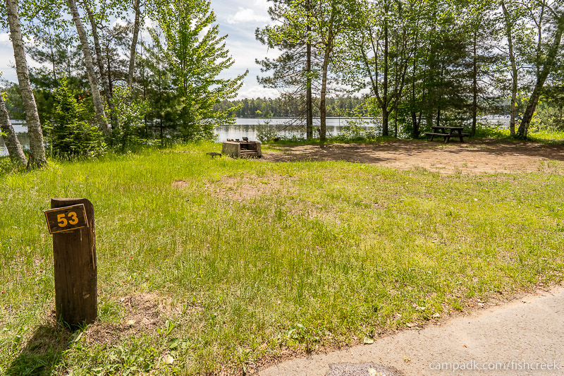 Campsite Photo of Site 63 at Fish Creek Pond Campground, New York - Looking at Site from Road Sign Visible