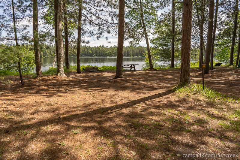 Campsite Photo of Site 74 at Fish Creek Pond Campground, New York - Looking at Site from Road Sign Visible