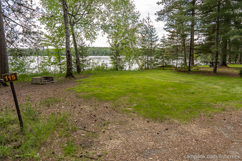 Campsite Photo of Site 147 at Fish Creek Pond Campground, New York - Looking at Site from Road Sign Visible
