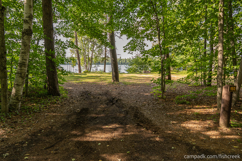 Campsite Photo of Site 220 at Fish Creek Pond Campground, New York - Looking at Site from Road Sign Visible