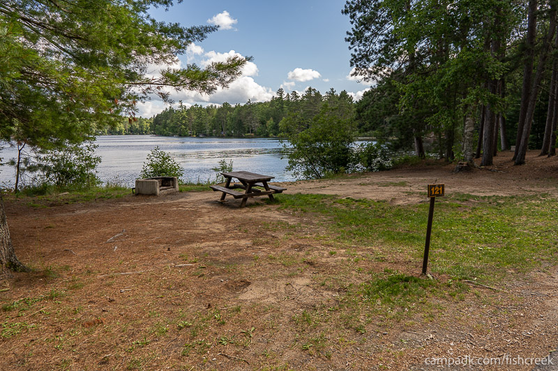 Campsite Photo of Site 153 at Fish Creek Pond Campground, New York - Looking at Site from Road Sign Visible