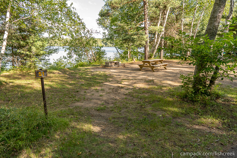 Campsite Photo of Site 61 at Fish Creek Pond Campground, New York - Looking at Site from Road Sign Visible