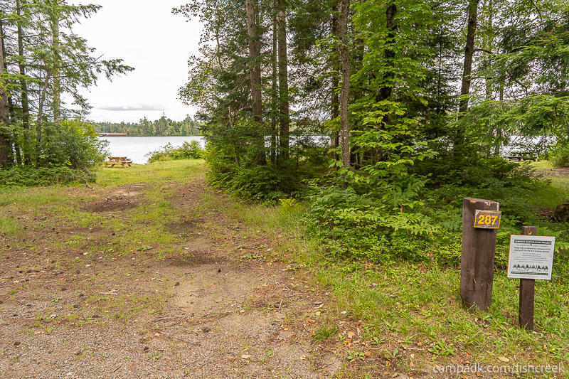 Campsite Photo of Site F314 at Fish Creek Pond Campground, New York - Looking at Site from Road Sign Visible