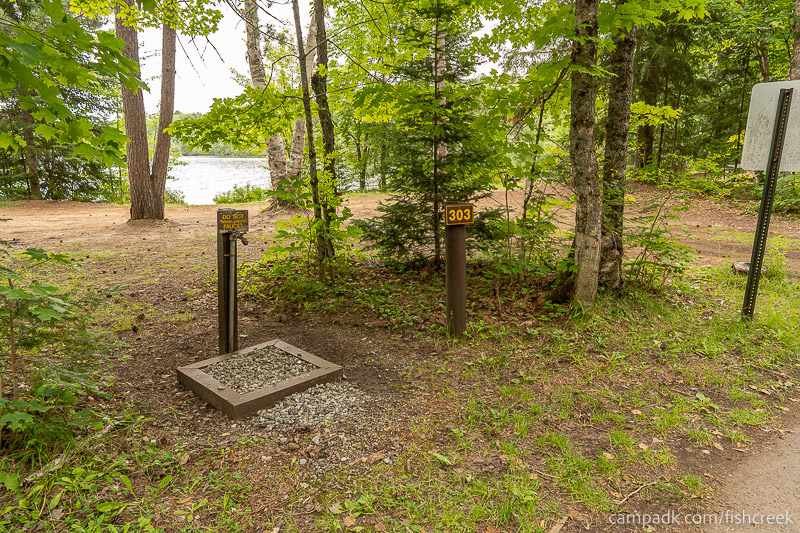 Campsite Photo of Site 329 at Fish Creek Pond Campground, New York - Looking at Site from Road Sign Visible
