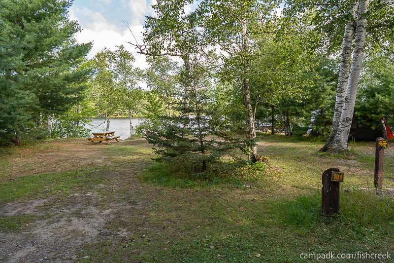 Campsite Photo of Site 210 at Fish Creek Pond Campground, New York - Looking at Site from Road Sign Visible