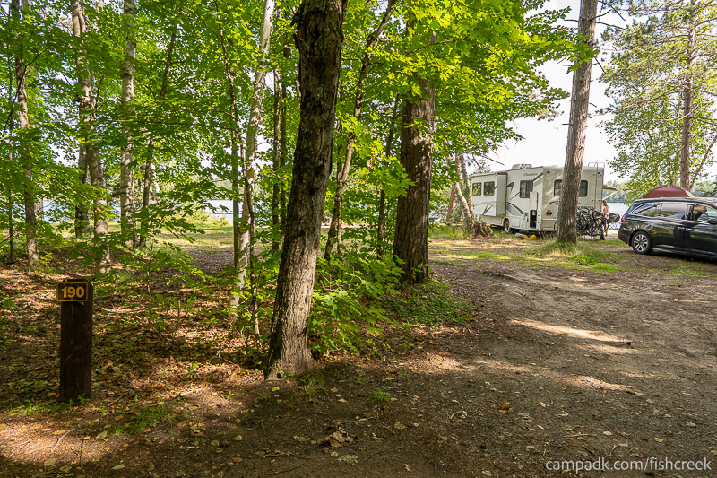Campsite Photo of Site 218 at Fish Creek Pond Campground, New York - Looking at Site from Road Sign Visible