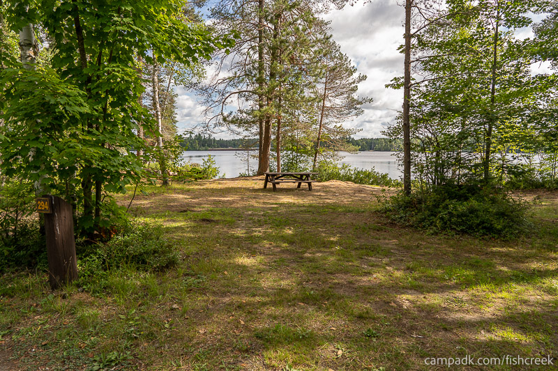 Campsite Photo of Site 320 at Fish Creek Pond Campground, New York - Looking at Site from Road Sign Visible