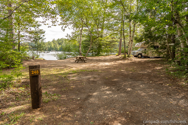 Campsite Photo of Site 276 at Fish Creek Pond Campground, New York - Looking at Site from Road Sign Visible