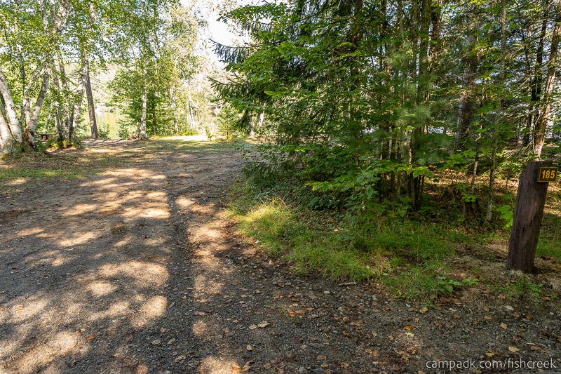 Campsite Photo of Site 213 at Fish Creek Pond Campground, New York - Looking at Site from Road Sign Visible