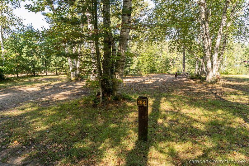 Campsite Photo of Site 212 at Fish Creek Pond Campground, New York - Looking at Site from Road Sign Visible