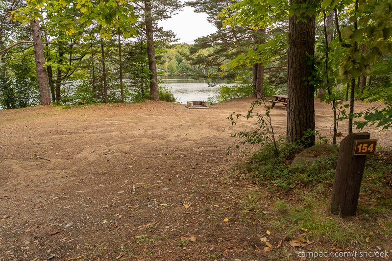 Campsite Photo of Site 184 at Fish Creek Pond Campground, New York - Looking at Site from Road Sign Visible