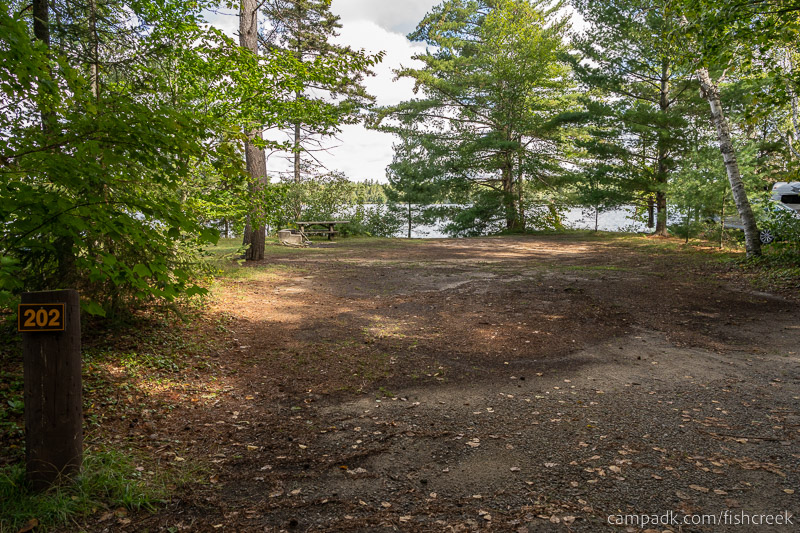 Campsite Photo of Site 230 at Fish Creek Pond Campground, New York - Looking at Site from Road Sign Visible
