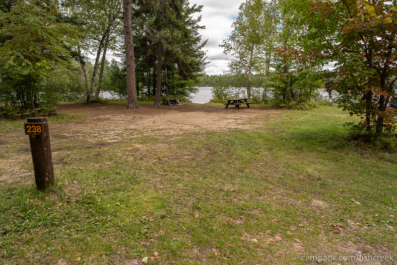 Campsite Photo of Site 266 at Fish Creek Pond Campground, New York - Looking at Site from Road Sign Visible
