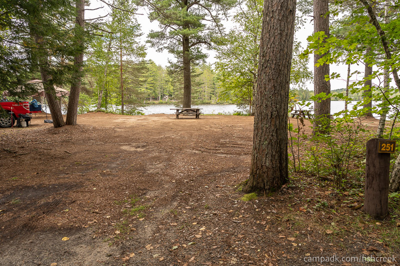 Campsite Photo of Site 279 at Fish Creek Pond Campground, New York - Looking at Site from Road Sign Visible